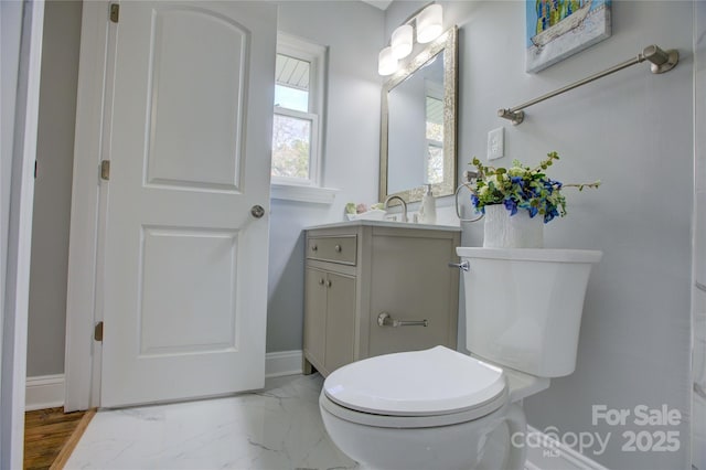 8607 Larchmont Cir, Charlotte, NC 28214 - bathroom with vanity, baseboards, toilet, and marble finish floors
