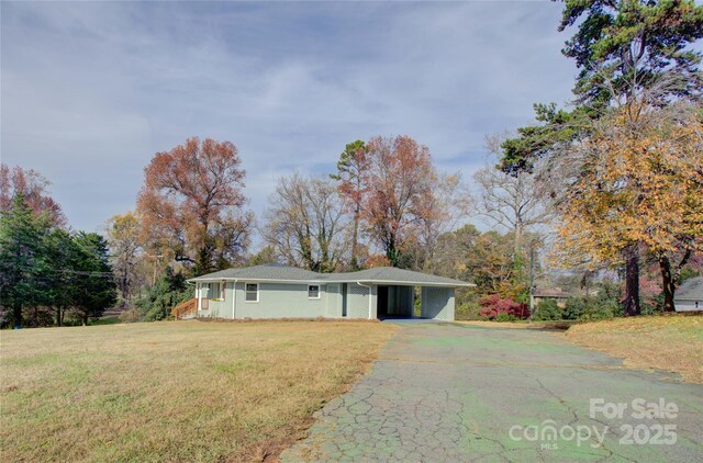 8607 Larchmont Cir, Charlotte, NC 28214 - view of front of property featuring asphalt driveway, a front lawn, and an attached carport