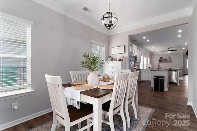 148 Kerri Dawn Ln, Locust, NC 28097 - dining space featuring crown molding, a chandelier, dark wood finished floors, a ceiling fan, and baseboards