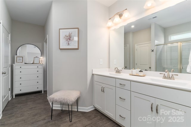 148 Kerri Dawn Ln, Locust, NC 28097 - full bathroom featuring double vanity, wood finished floors, a stall shower, and baseboards