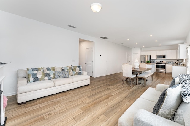 3077 Light Ridge Ct SW, Concord, NC 28027 - living area with light wood-type flooring, recessed lighting, and baseboards