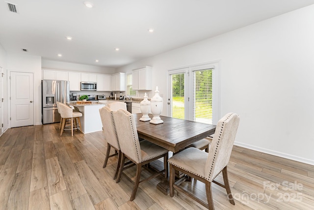 3077 Light Ridge Ct SW, Concord, NC 28027 - dining room featuring light wood-style flooring, recessed lighting, and baseboards