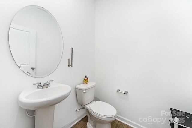 3077 Light Ridge Ct SW, Concord, NC 28027 - half bath featuring wood finished floors, baseboards, and toilet