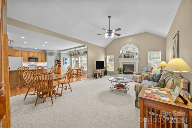 6533 Derby Ln NW, Concord, NC 28027 - living area with ceiling fan, a glass covered fireplace, vaulted ceiling, recessed lighting, and light colored carpet