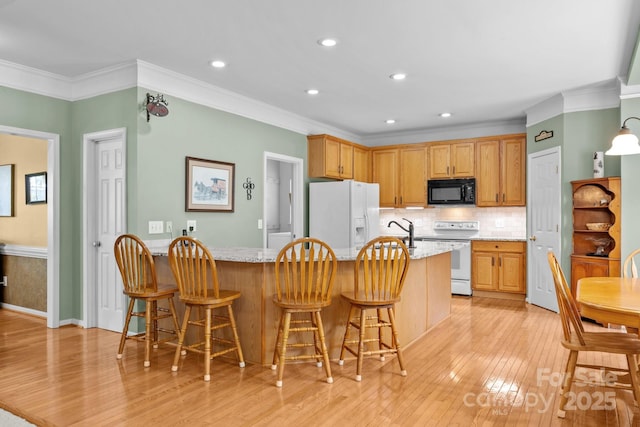 6533 Derby Ln NW, Concord, NC 28027 - kitchen with white appliances, crown molding, light wood-type flooring, tasteful backsplash, and light stone counters