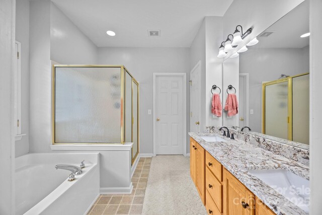6533 Derby Ln NW, Concord, NC 28027 - bathroom with a stall shower, a garden tub, double vanity, and baseboards
