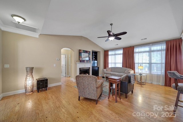 909 Autumn Glen Ct, Clover, SC 29710 - living room featuring arched walkways, a ceiling fan, vaulted ceiling, light wood-style floors, and a fireplace