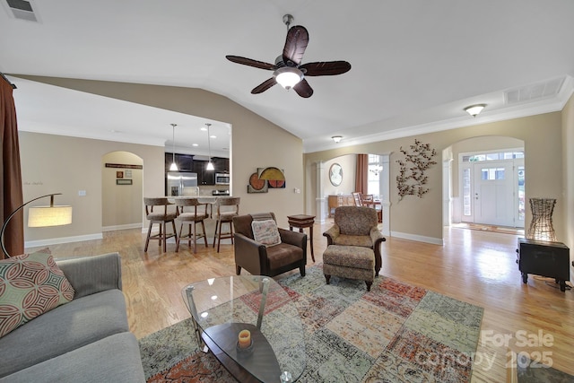 909 Autumn Glen Ct, Clover, SC 29710 - living room featuring arched walkways, lofted ceiling, ornamental molding, ceiling fan, and light wood-type flooring
