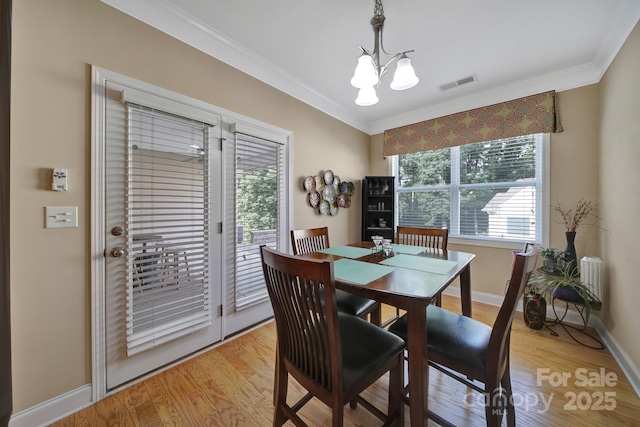909 Autumn Glen Ct, Clover, SC 29710 - dining area with a chandelier, ornamental molding, baseboards, and light wood-style flooring