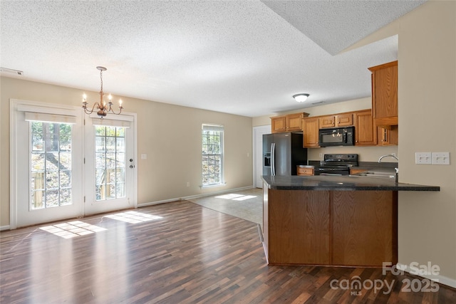 116 Dean Rd, Anderson, SC 29625 - kitchen featuring black appliances, a textured ceiling, a sink, dark wood finished floors, and a peninsula
