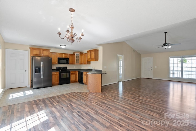 116 Dean Rd, Anderson, SC 29625 - kitchen with black appliances, open floor plan, vaulted ceiling, light wood-style floors, and a chandelier