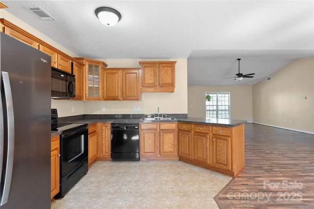 116 Dean Rd, Anderson, SC 29625 - kitchen featuring black appliances, a sink, a peninsula, a ceiling fan, and brown cabinets