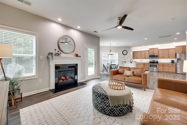 424 Castlebury Ct, Clover, SC 29710 - living room featuring wood finished floors, ceiling fan, recessed lighting, a glass covered fireplace, and baseboards