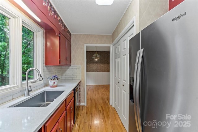 460 27th Avenue Cir NW, Hickory, NC 28601 - kitchen featuring stainless steel refrigerator with ice dispenser, wallpapered walls, a sink, light countertops, and light wood-type flooring