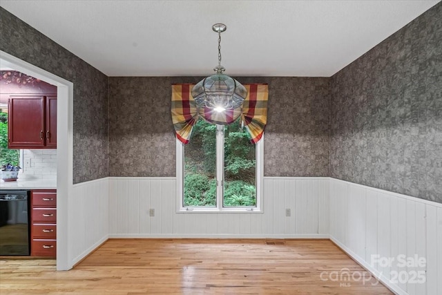 460 27th Avenue Cir NW, Hickory, NC 28601 - unfurnished dining area with light wood finished floors, healthy amount of natural light, a wainscoted wall, and wallpapered walls