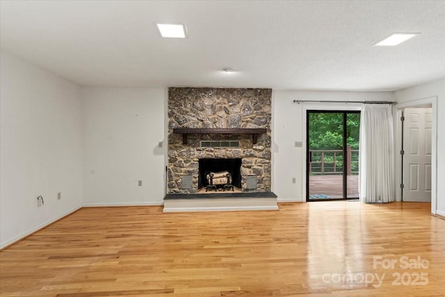 460 27th Avenue Cir NW, Hickory, NC 28601 - unfurnished living room with wood finished floors, a fireplace, and baseboards