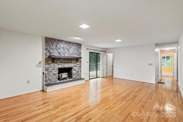 460 27th Avenue Cir NW, Hickory, NC 28601 - unfurnished living room featuring wood finished floors, a stone fireplace, and baseboards