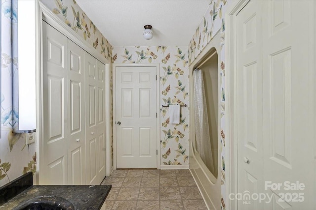460 27th Avenue Cir NW, Hickory, NC 28601 - bathroom with wallpapered walls, a closet, baseboards, and shower / bath combo with shower curtain