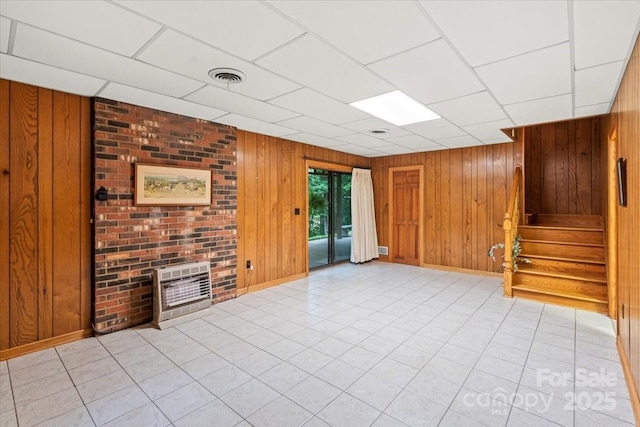 460 27th Avenue Cir NW, Hickory, NC 28601 - unfurnished living room with wooden walls, stairway, heating unit, a drop ceiling, and baseboards
