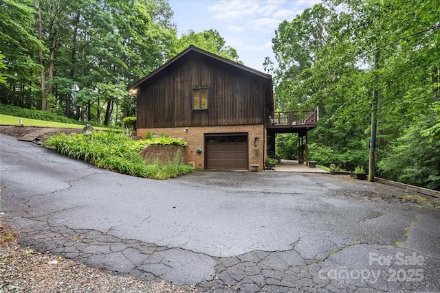 460 27th Avenue Cir NW, Hickory, NC 28601 - view of property exterior with driveway, a wooden deck, a garage, and brick siding