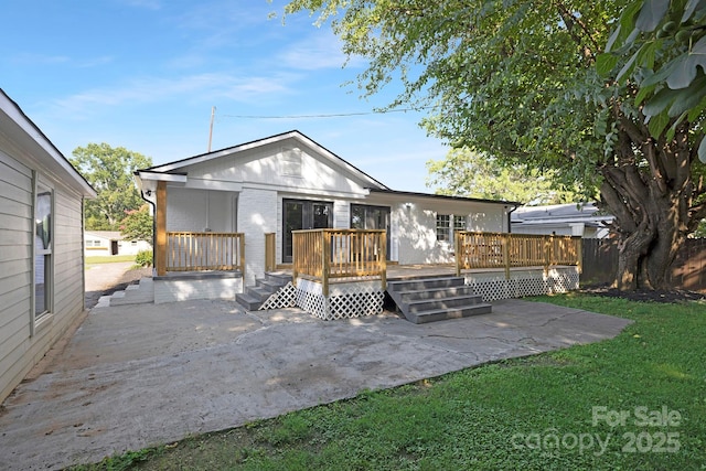 4838 Keats Ave, Charlotte, NC 28212 - back of house featuring a patio area, a deck, brick siding, and a lawn