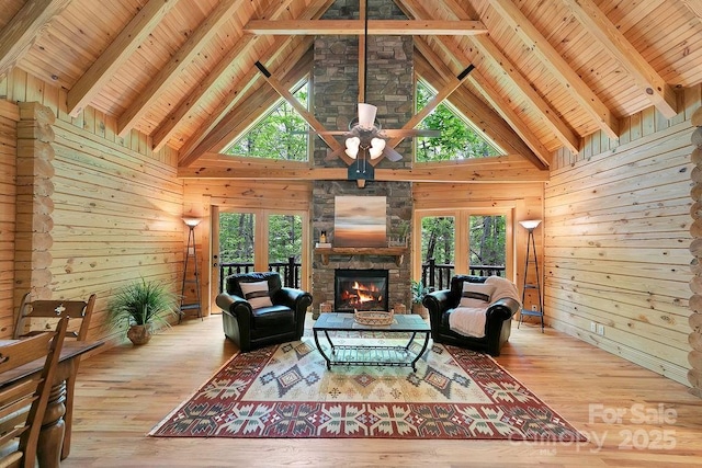 76 Isuhdavga Ct, Brevard, NC 28712 - living area with wood walls, a stone fireplace, french doors, wood-type flooring, and healthy amount of natural light