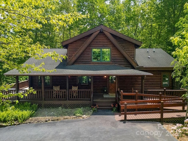 76 Isuhdavga Ct, Brevard, NC 28712 - log-style house featuring a shingled roof, log siding, and a porch