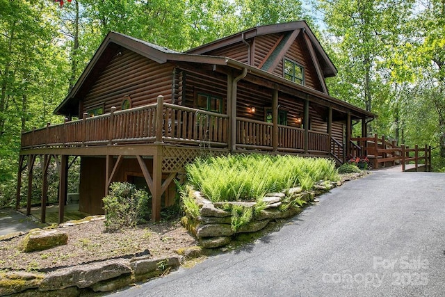 76 Isuhdavga Ct, Brevard, NC 28712 - log-style house with covered porch and log siding