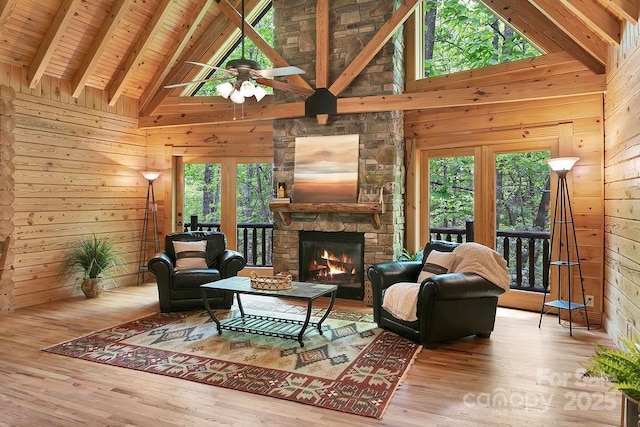 76 Isuhdavga Ct, Brevard, NC 28712 - living area featuring wooden walls, wood finished floors, high vaulted ceiling, a stone fireplace, and wood ceiling with exposed beams
