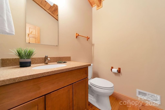 76 Isuhdavga Ct, Brevard, NC 28712 - half bathroom with vanity, toilet, and wood finished floors