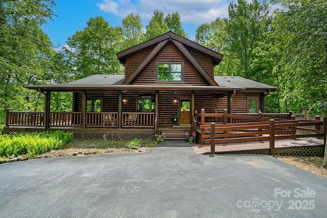 76 Isuhdavga Ct, Brevard, NC 28712 - log cabin featuring log siding, a shingled roof, and a wooden deck