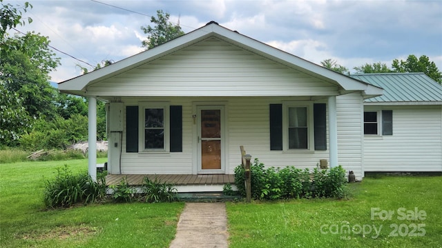 85 Oshea Ln, Waynesville, NC 28786 - bungalow with a porch, a front lawn, and metal roof