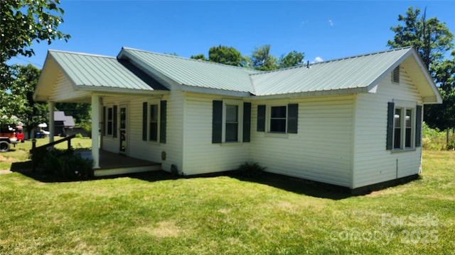 85 Oshea Ln, Waynesville, NC 28786 - view of property exterior with a lawn, metal roof, and covered porch