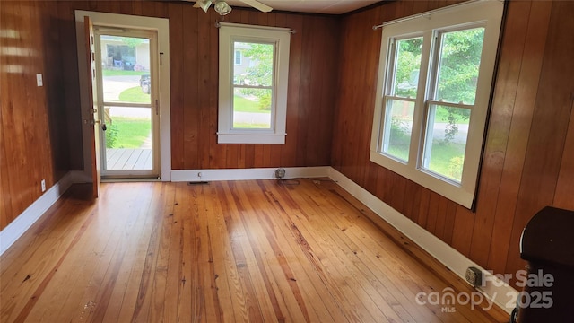 85 Oshea Ln, Waynesville, NC 28786 - unfurnished room featuring light wood-type flooring, wooden walls, and baseboards