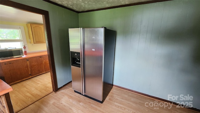 85 Oshea Ln, Waynesville, NC 28786 - kitchen with stainless steel appliances, light wood finished floors, ornamental molding, a textured ceiling, and light countertops