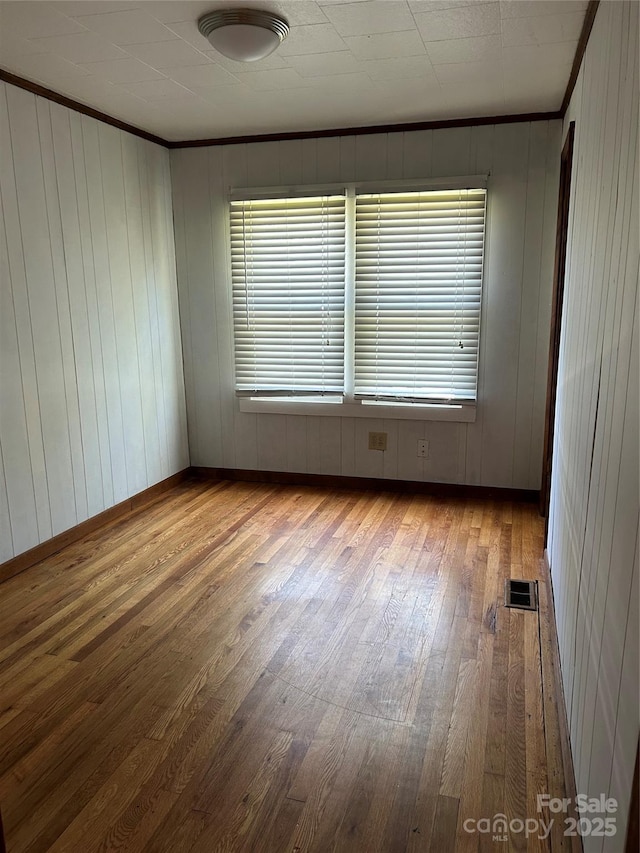 85 Oshea Ln, Waynesville, NC 28786 - unfurnished room with wood-type flooring, ornamental molding, healthy amount of natural light, and baseboards
