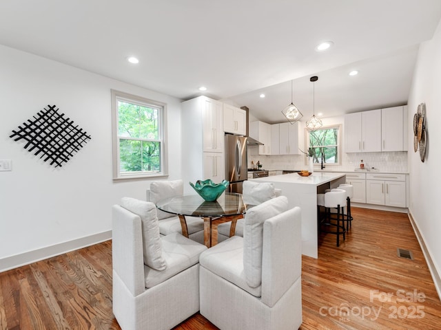 2114 Thurmond Pl, Charlotte, NC 28205 - dining space featuring healthy amount of natural light, light wood-style floors, recessed lighting, and baseboards