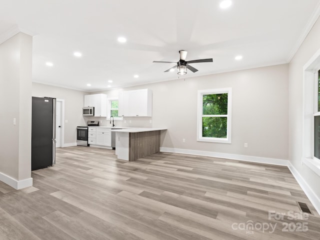 123 Edwards Ave, Swannanoa, NC 28778 - kitchen featuring stainless steel appliances, a peninsula, open floor plan, baseboards, and ornamental molding