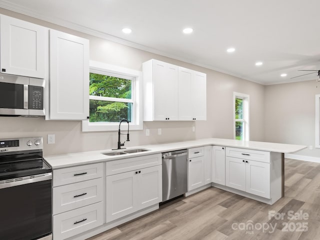123 Edwards Ave, Swannanoa, NC 28778 - kitchen featuring appliances with stainless steel finishes, a sink, a peninsula, light countertops, and white cabinets