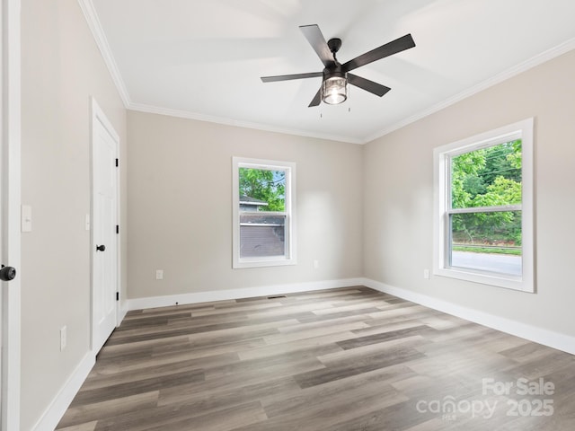 123 Edwards Ave, Swannanoa, NC 28778 - unfurnished room with plenty of natural light, crown molding, a ceiling fan, wood finished floors, and baseboards