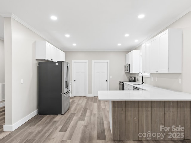 123 Edwards Ave, Swannanoa, NC 28778 - kitchen featuring stainless steel appliances, crown molding, recessed lighting, baseboards, and light countertops