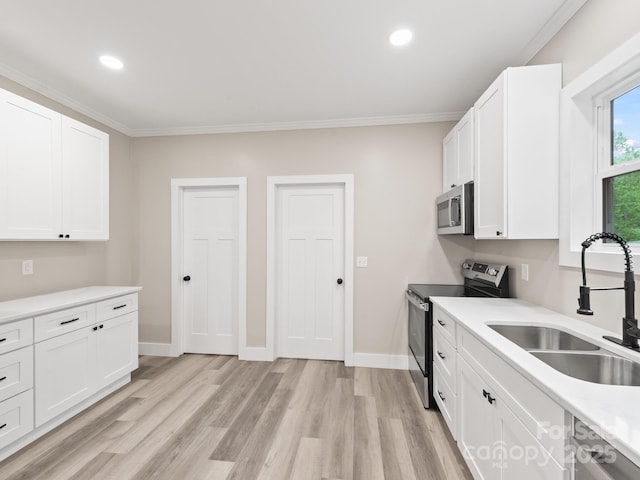 123 Edwards Ave, Swannanoa, NC 28778 - kitchen with appliances with stainless steel finishes, a sink, light wood-style flooring, white cabinets, and recessed lighting