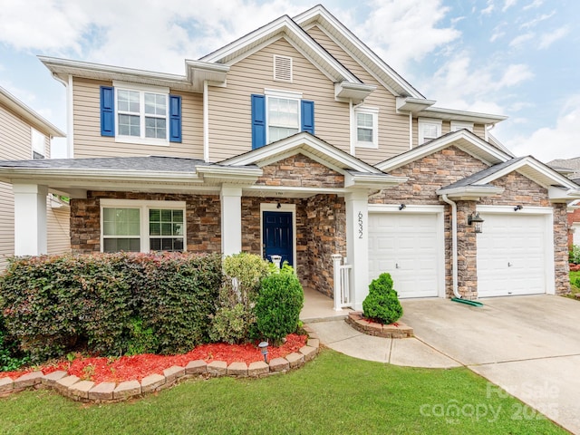 6532 Prosperity Commons Dr, Charlotte, NC 28269 - view of front of property featuring concrete driveway, stone siding, and a garage