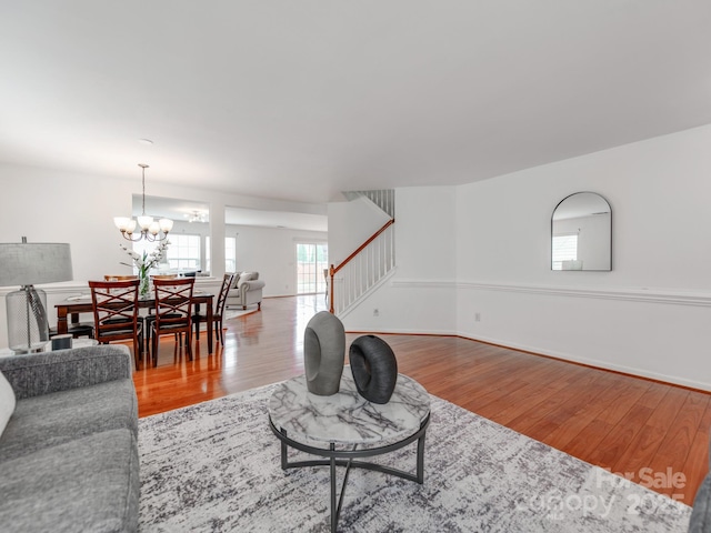 6532 Prosperity Commons Dr, Charlotte, NC 28269 - living room with stairway, wood finished floors, and a chandelier