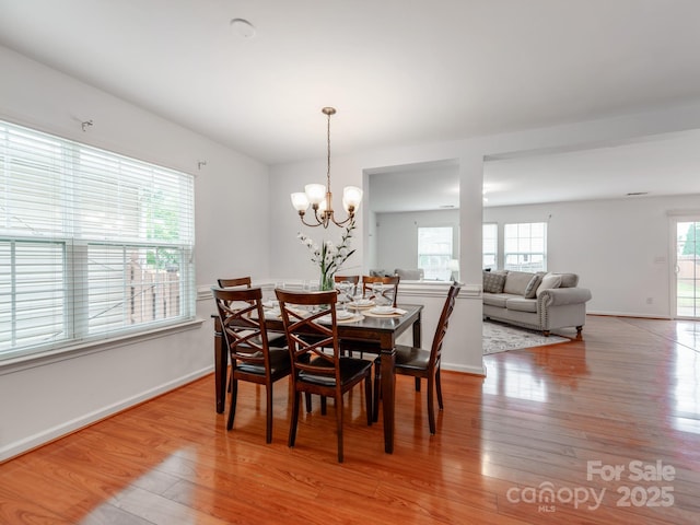 6532 Prosperity Commons Dr, Charlotte, NC 28269 - dining space with light wood-type flooring, baseboards, and a chandelier
