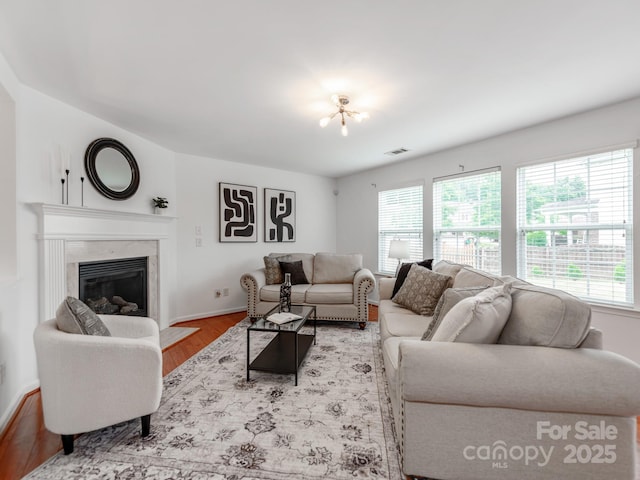 6532 Prosperity Commons Dr, Charlotte, NC 28269 - living room featuring wood finished floors, healthy amount of natural light, a high end fireplace, and baseboards