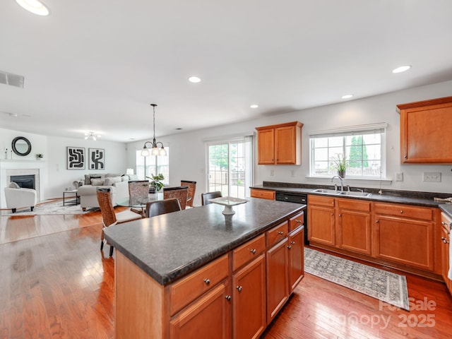 6532 Prosperity Commons Dr, Charlotte, NC 28269 - kitchen with a sink, dark countertops, hardwood / wood-style floors, a center island, and recessed lighting