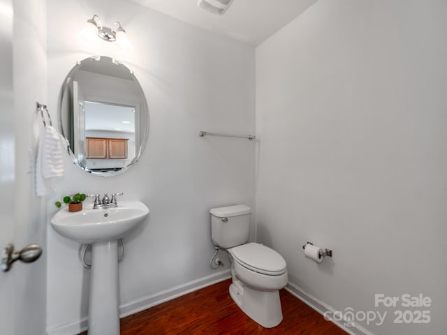 6532 Prosperity Commons Dr, Charlotte, NC 28269 - bathroom featuring wood finished floors, toilet, baseboards, and a sink