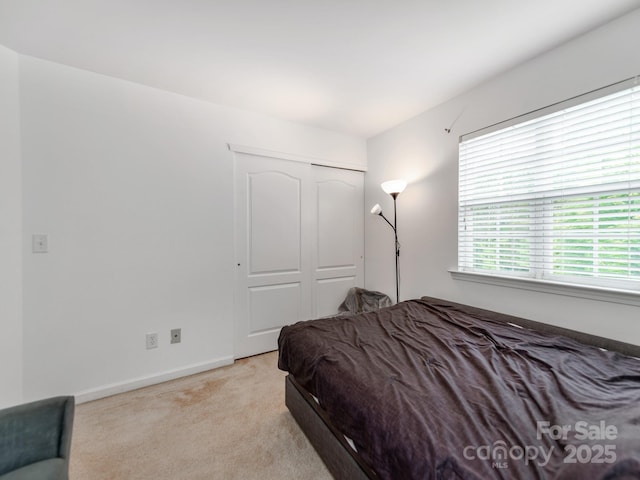 6532 Prosperity Commons Dr, Charlotte, NC 28269 - bedroom featuring light colored carpet, a closet, and baseboards
