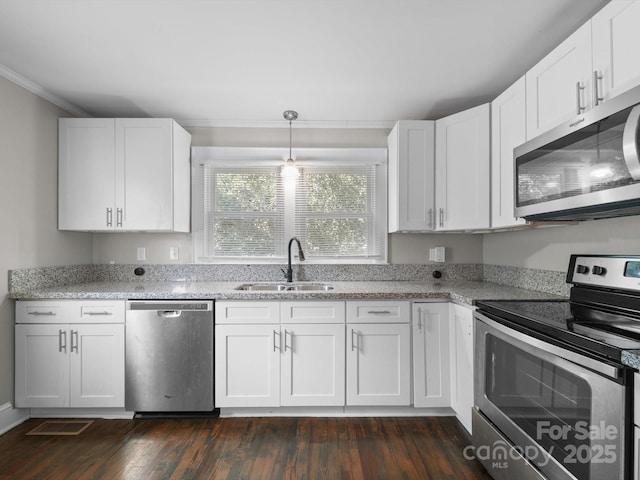 322 Peachtree St, Albemarle, NC 28001 - kitchen featuring stainless steel appliances, dark wood-style flooring, white cabinets, crown molding, and light stone counters